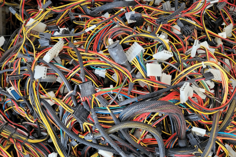 A close-up of a tangled bundle of colorful electrical wires and connectors, highlighting the complexity of cable installation in technology and electronics