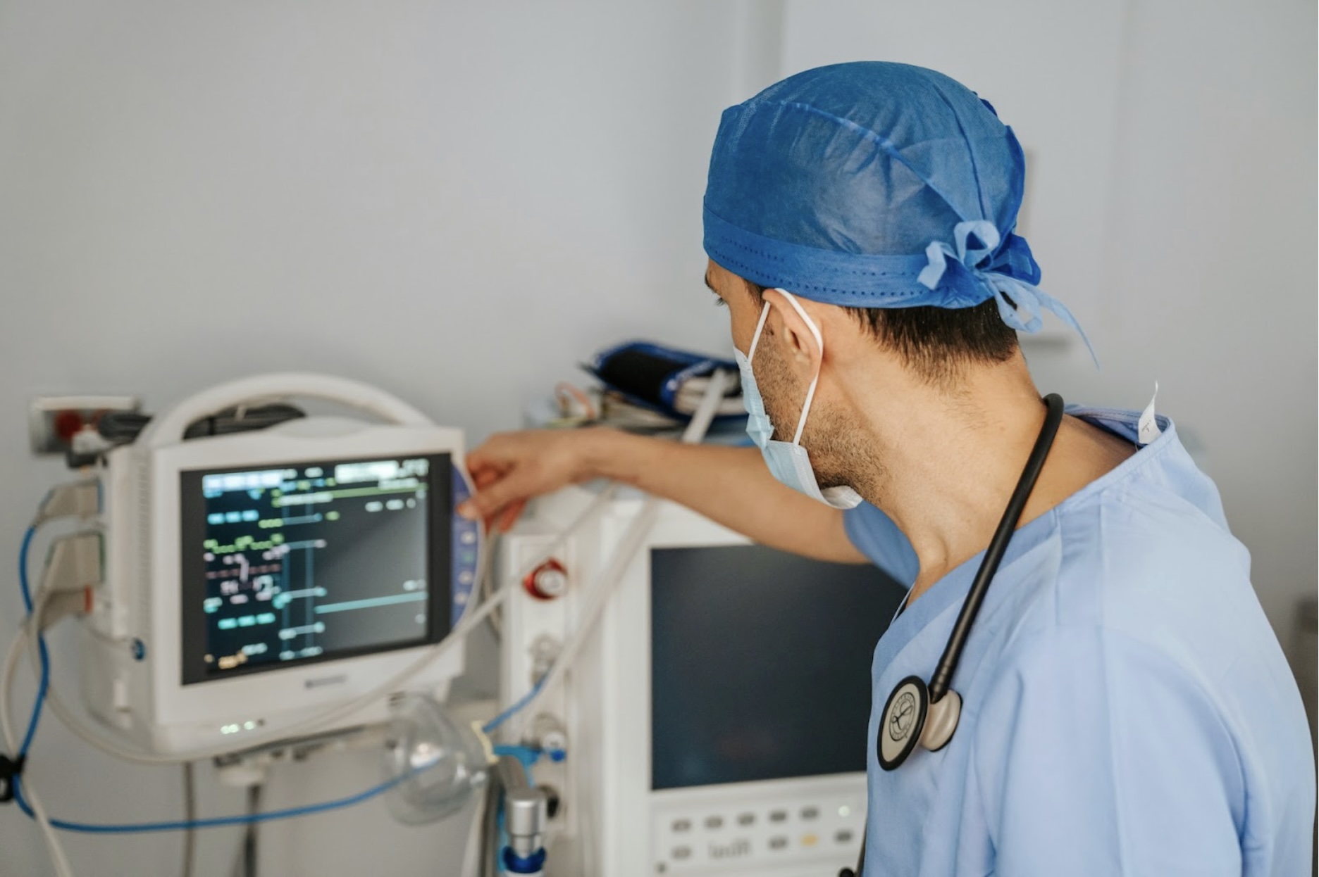Healthcare professional monitors patient data on AV-integrated medical equipment, highlighting the importance of reliable low-voltage AV cables in hospital environments for uninterrupted performance and communication.