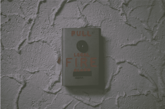 Wall-mounted local fire alarm pull station highlighting the importance of fire safety systems and the role of fire life safety plenum wire in meeting modern fire safety codes
