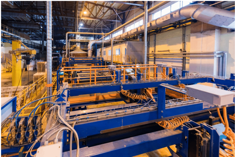 An industrial facility with heavy-duty machinery, wiring, and cable management systems, showcasing the reliability and strength of durable petroleum cables in harsh environments