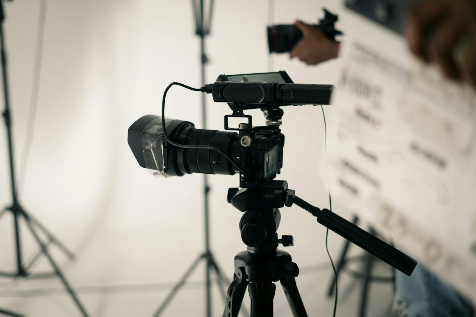 Professional broadcast camera setup using wireless transmission supported by wired AV cabling.