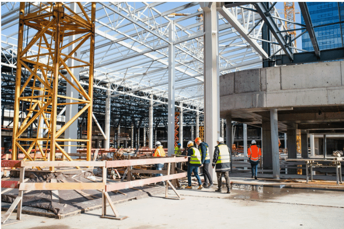 Construction site with workers, highlighting the importance of corrosion-resistant wire in ensuring the durability and longevity of building materials