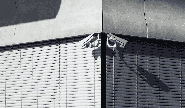 A building corner with two security cameras, highlighting the use of multi-pair cables in security system multicable solutions for reliable signal transmission