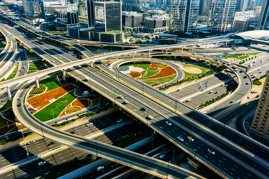 Aerial view of a modern multi-level highway interchange in a major city, symbolizing efficient transportation networks and fast nationwide logistics.