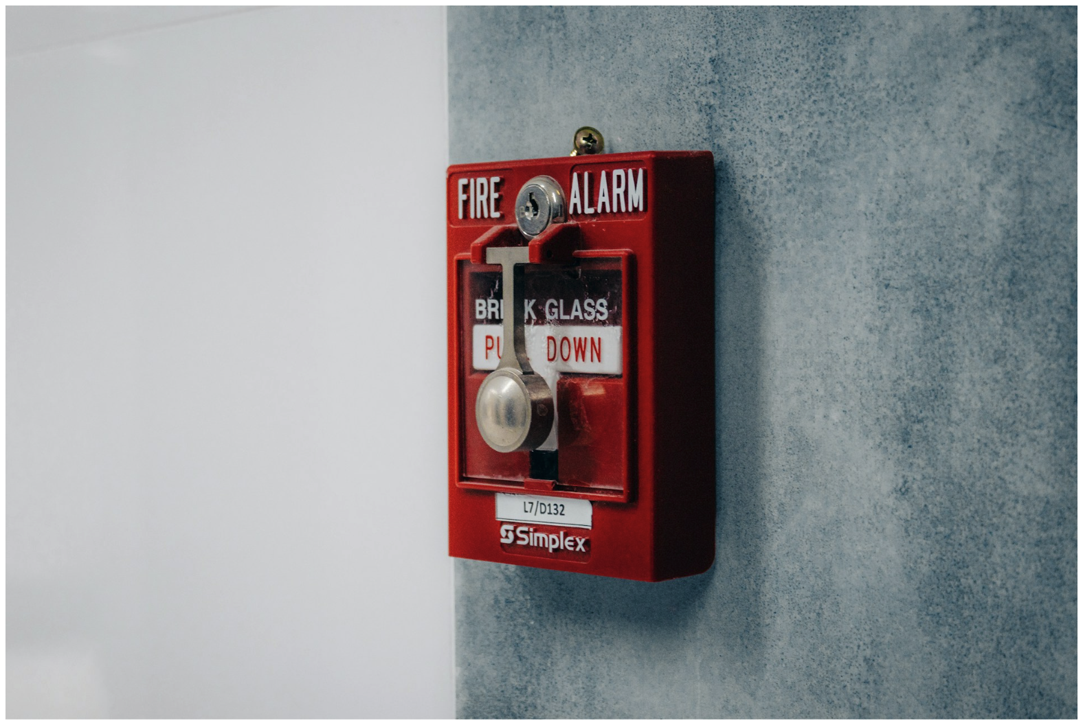 Fire alarm pull station mounted on wall, representing commercial fire alarm systems where 14 AWG fire systems wire supports reliable signal and power distribution