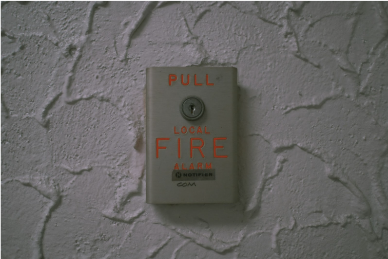 Wall-mounted fire alarm pull station used in commercial fire alarm systems illustrating life safety signaling devices connected by fire alarm cable and wiring