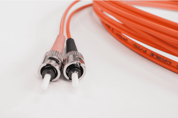 Close-up of multimode fiber optic connectors and orange cable, illustrating key differences in fiber optic cable types for data transmission