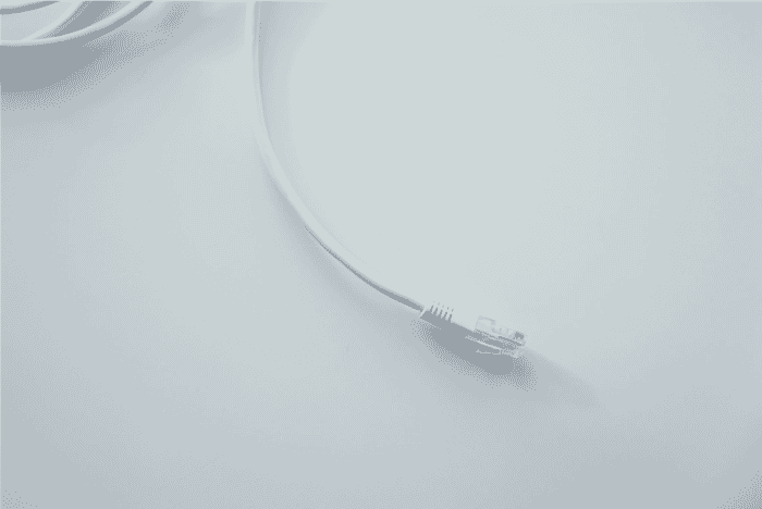 White outdoor Ethernet cable with an RJ45 connector on a white background, ideal for direct burial Cat6 applications and network cable outside setups. Suitable for reliable outdoor LAN cable installations, ensuring a durable outdoor wire and cable solution
