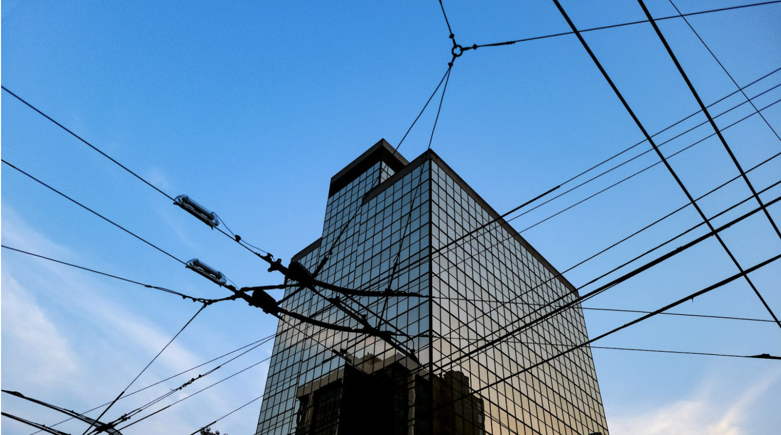 Outdoor wire and cable exposed to environmental conditions near a commercial building.