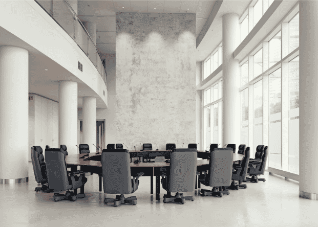 Modern conference room with a large table surrounded by office chairs, highlighting the importance of high-quality Ethernet cables like Cat6a for reliable, long-distance connectivity in commercial environments