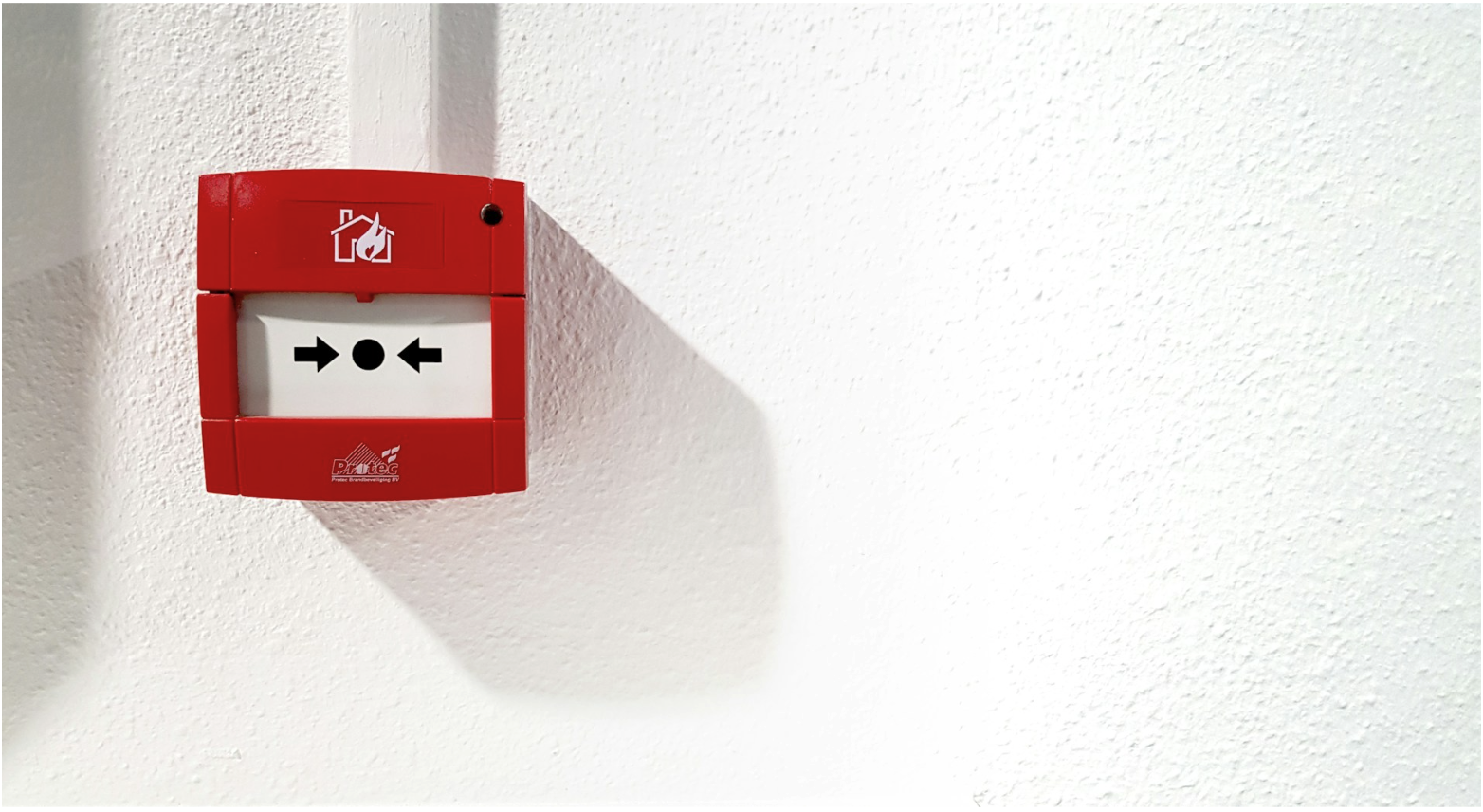 Fire alarm wall device in commercial building, illustrating life safety systems where 16 AWG fire alarm wire supports reliable signal and power distribution