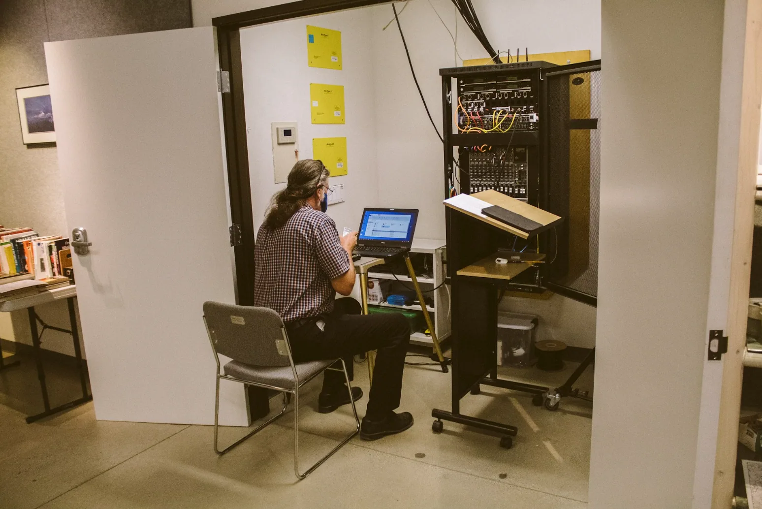 Network technician configuring a commercial structured cabling rack with Ethernet switches and patch panels to support Cat5e, Cat6, and Cat6a network infrastructure.