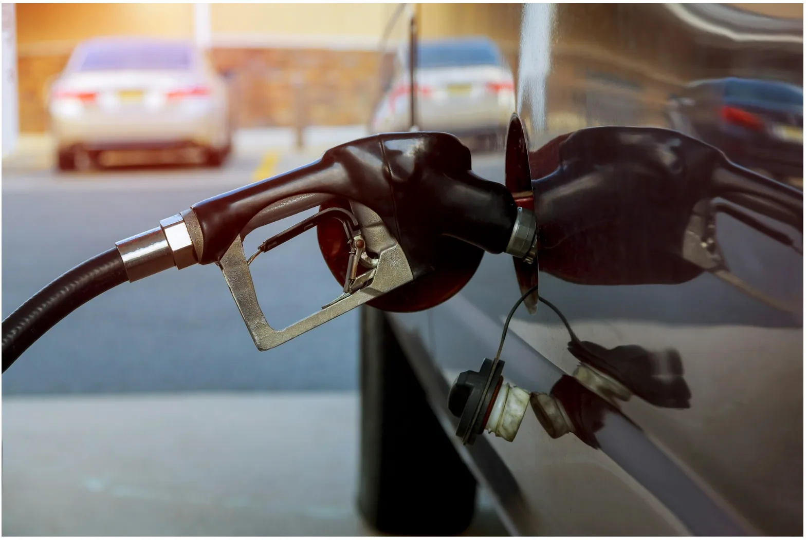 Fuel dispenser nozzle at a commercial gas station representing petroleum environments where FEP Category 5e cables support forecourt communication and monitoring systems