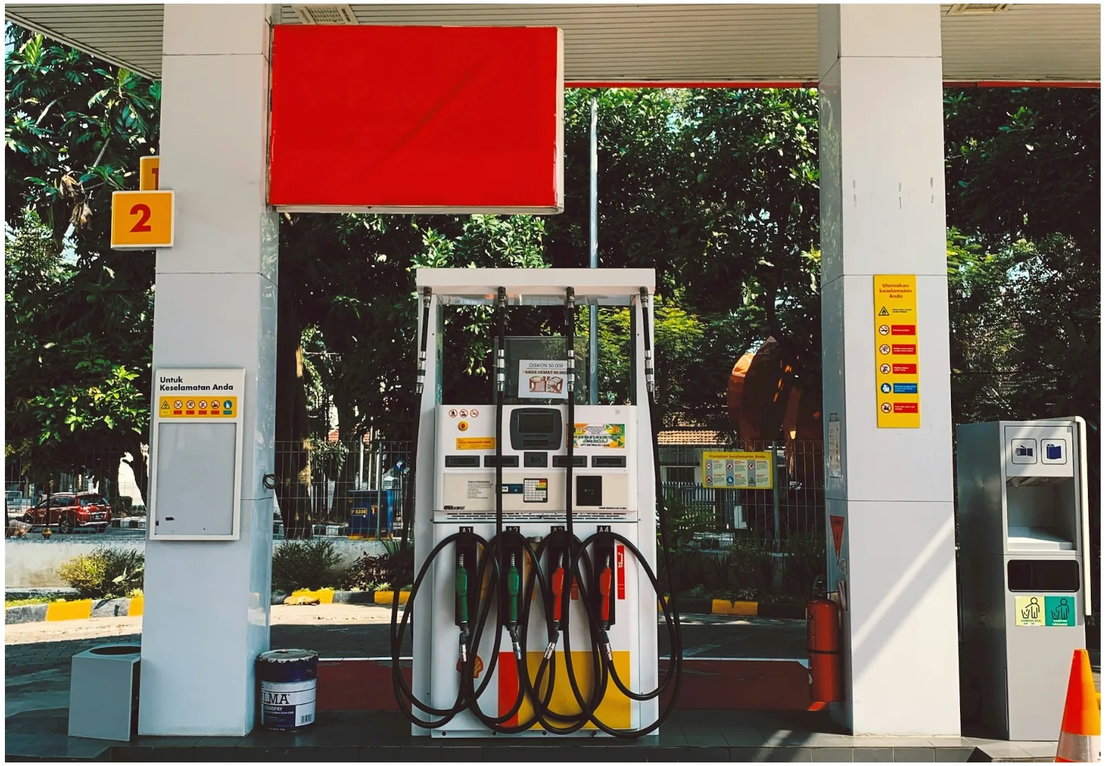 Gas station fuel dispenser connected to EMV payment, monitoring, and low-voltage communication systems in a petroleum forecourt environment