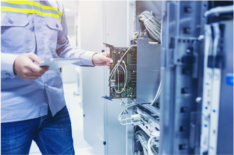 Technician servicing a commercial network cabinet with structured cabling, illustrating enterprise infrastructure where Cat6a and Cat7 support high-speed data transmission and reliable network performance