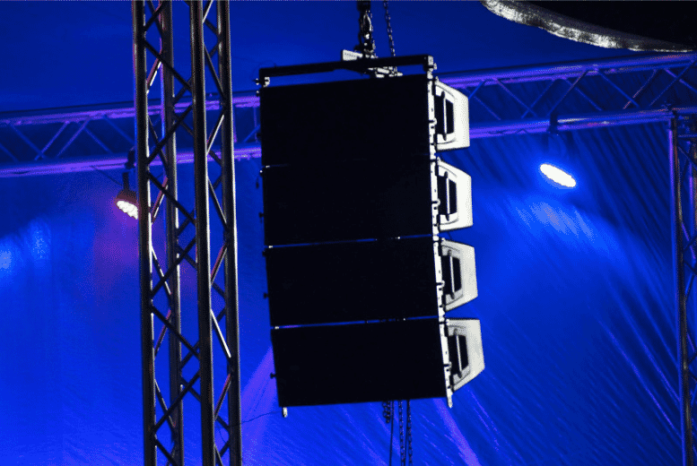 Suspended speaker system in an industrial AV setup, highlighting the importance of choosing the right speaker wire for clear sound transmission in large commercial installations