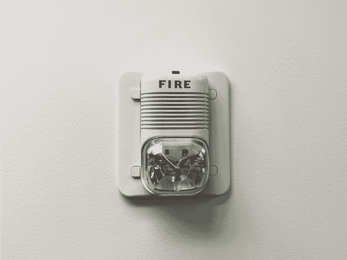 Wall-mounted fire alarm with fire-resistant insulation showcasing the importance of 2-hour fire-resistive cables and cabling for maintaining safety and functionality in critical systems