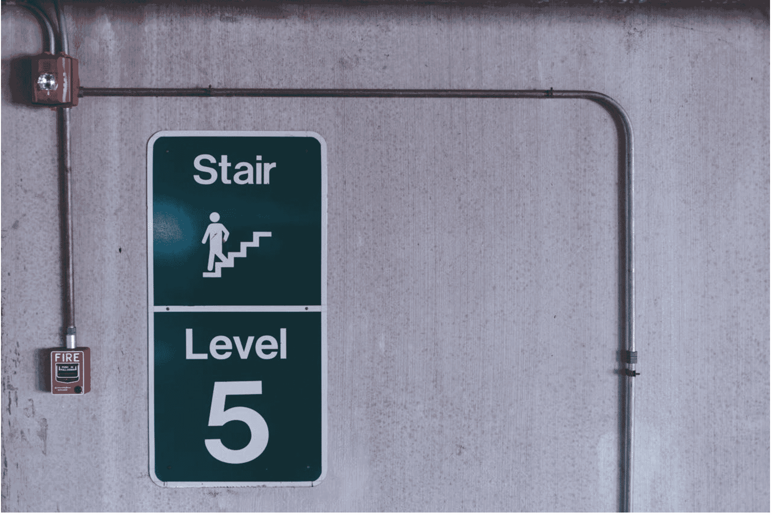 tairwell on level 5 with visible fire alarm and conduit pipes, illustrating the importance of using low smoke cables in critical safety environments like stairwells for enhanced fire safety and containment