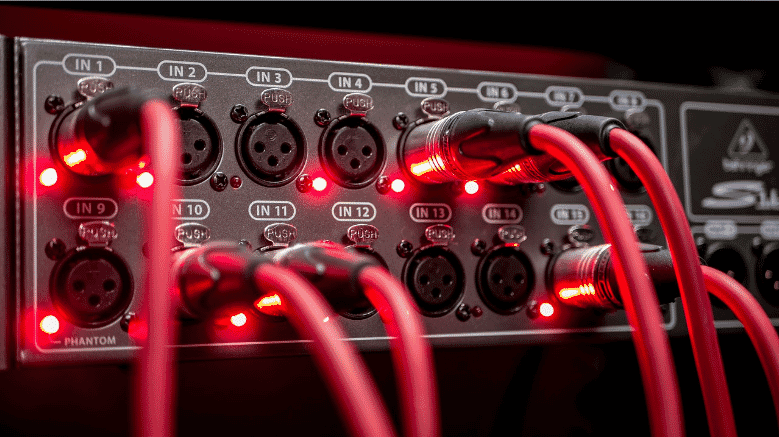 Close-up of AV control cables connected to a professional audio interface, showcasing the importance of high-quality, reliable cabling in ensuring optimal performance and signal integrity in commercial and industrial AV setups