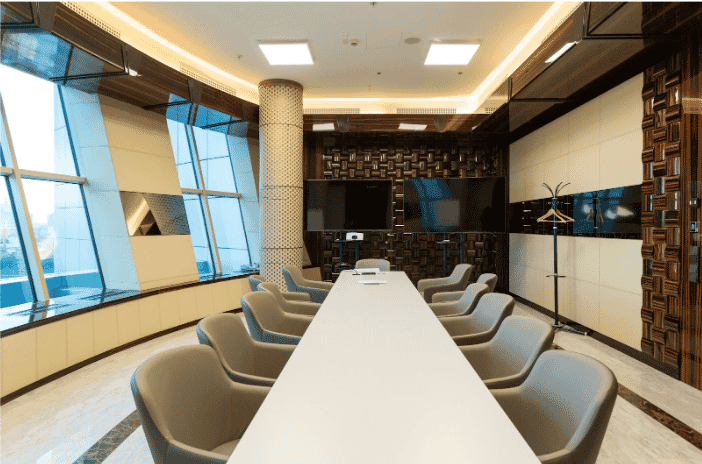 Modern conference room featuring an advanced AV system integration setup with dual displays and seamless connectivity, optimized using high-quality AV Plenum Composite Cables for reliable performance