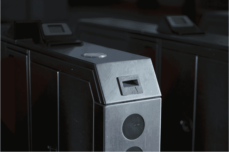Close-up of an access control turnstile with a card reader slot, showcasing the critical role of multi-conductor composite cables in streamlining security system installation and enhancing performance in corporate, healthcare, and retail environments