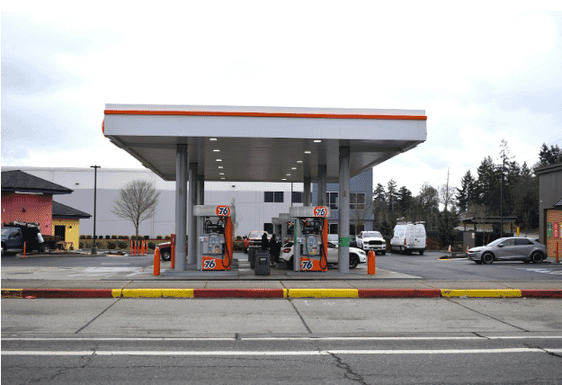 A 76 gas station with two fuel pumps, symbolizing environments where cables are exposed to oil, emphasizing the need for oil-resistant cables in industrial settings. Oil-resistant cables help maintain reliability and safety by resisting oil exposure degradation, which is crucial for automotive, manufacturing, and energy systems
