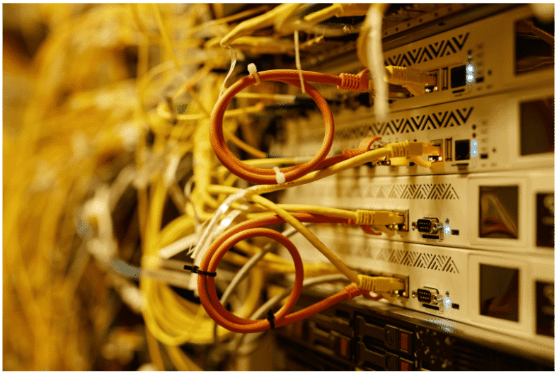 Close-up of an intricate network of AV cables connected to a server, illustrating the importance of choosing the right HD AV cables for seamless video transmission