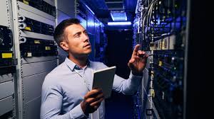 AV integrator reviewing installed components on a server rack