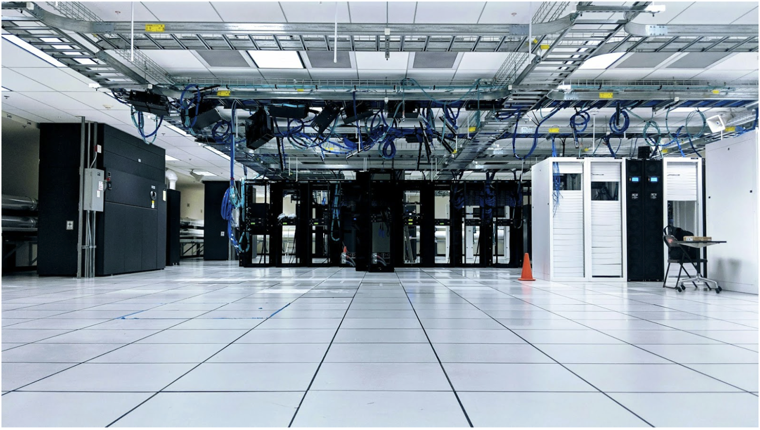 Data center with structured cabling and overhead fiber pathways illustrating enterprise network infrastructure using OM1 vs OM3 multimode fiber and pre-terminated fiber optic cable systems