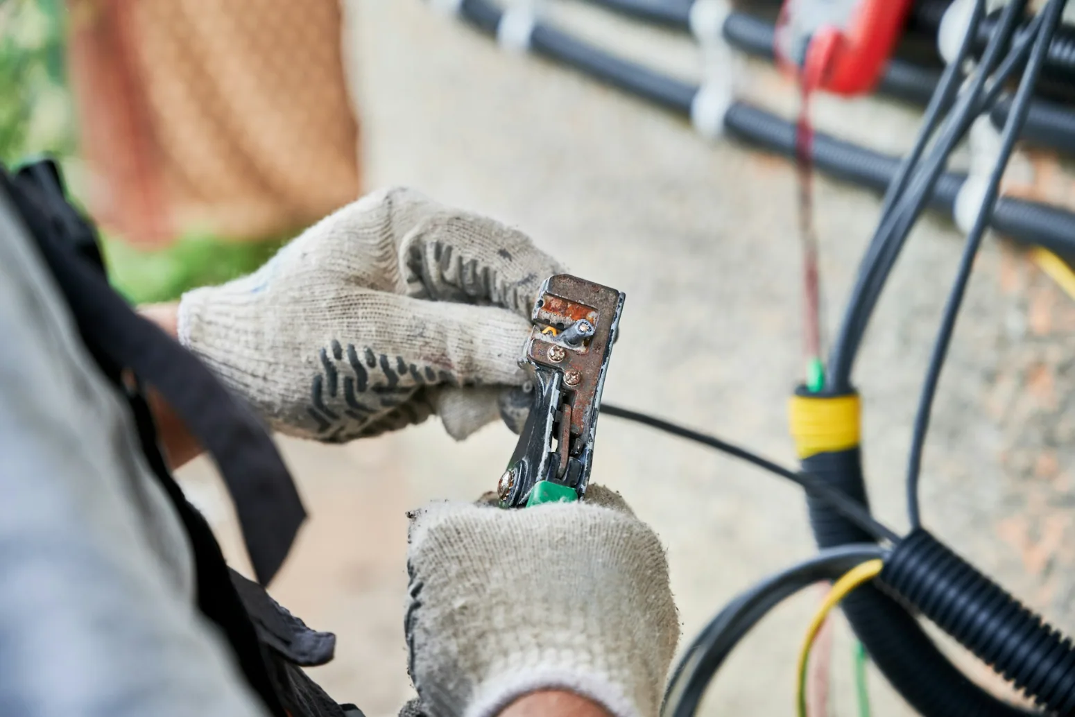Technician terminating an outdoor Category 6 Ethernet cable during a commercial network installation, illustrating direct burial Cat6 and exterior cable deployment.