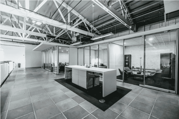 This modern commercial office space showcases advanced building wire infrastructure, including building automation wire integrated into the ceiling. The clean, minimalist design highlights commercial building wiring solutions that support smart building wiring systems. The use of low-voltage building automation cables enhances energy efficiency and system integration. This layout exemplifies energy-efficient building and industrial automation wiring designed for operational excellence and sustainability